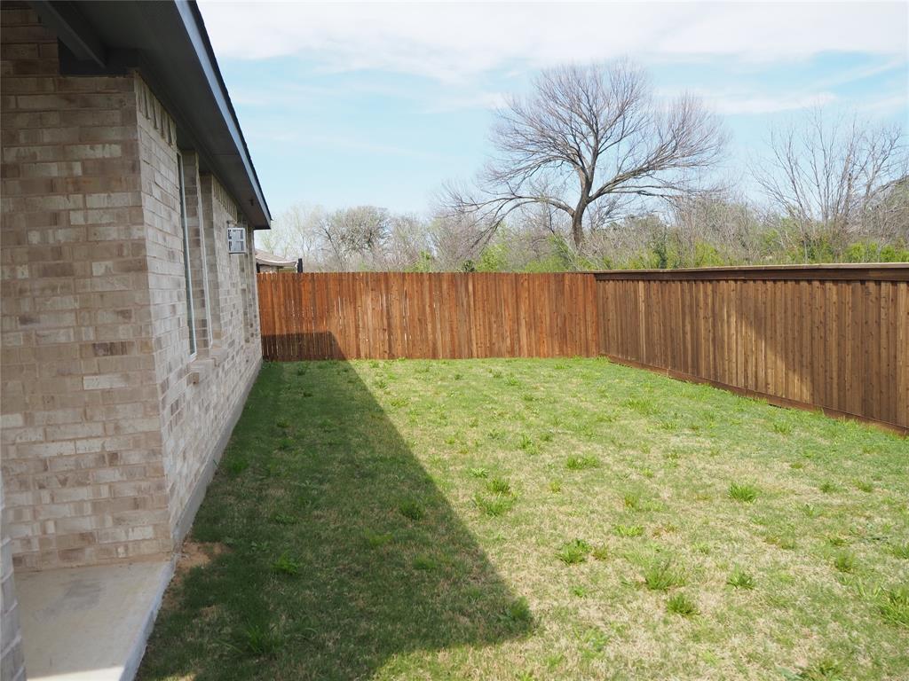 2201 Yellowhammer Road Denton, TX 76205 - Photo 33 of 36 a backyard of a house with lots of green space