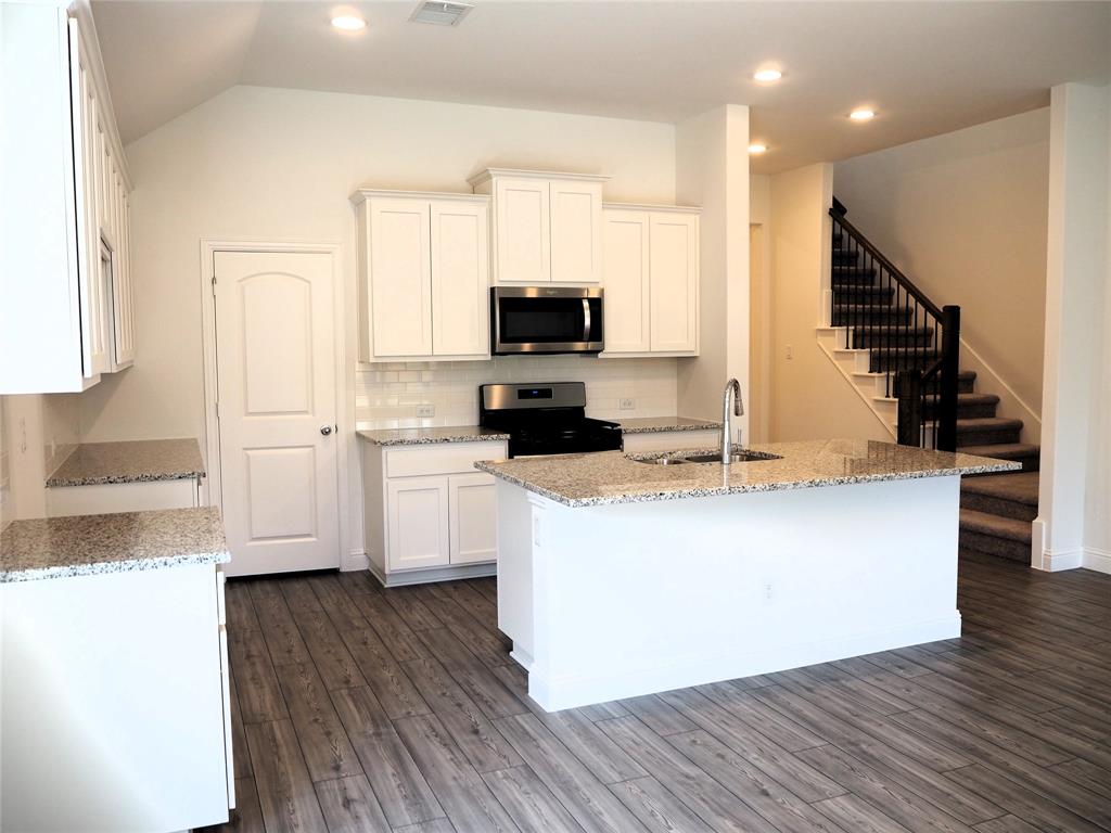 2201 Yellowhammer Road Denton, TX 76205 - Photo 5 of 36 a living room with stainless steel appliances kitchen island granite countertop a stove and a refrigerator
