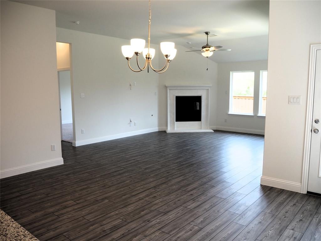 2201 Yellowhammer Road Denton, TX 76205 - Photo 9 of 36 a view of an empty room with wooden floor and a window