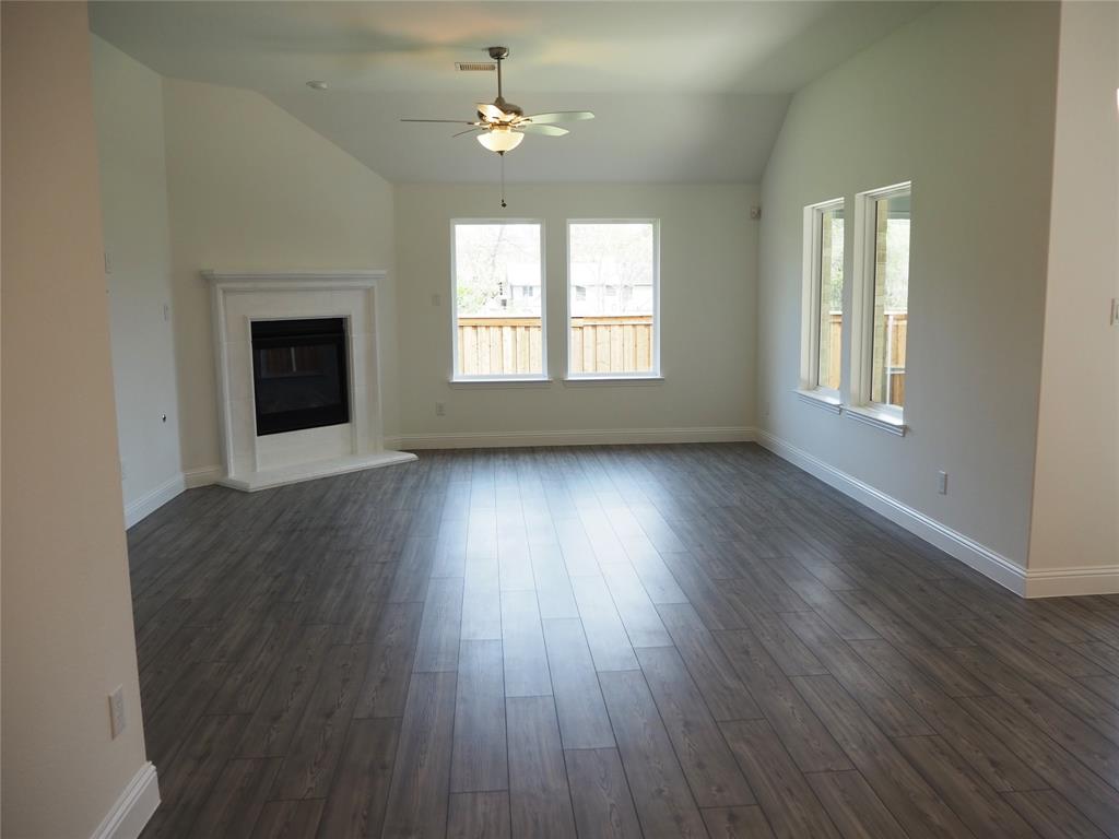 2201 Yellowhammer Road Denton, TX 76205 - Photo 10 of 36 a view of an empty room with wooden floor and a window