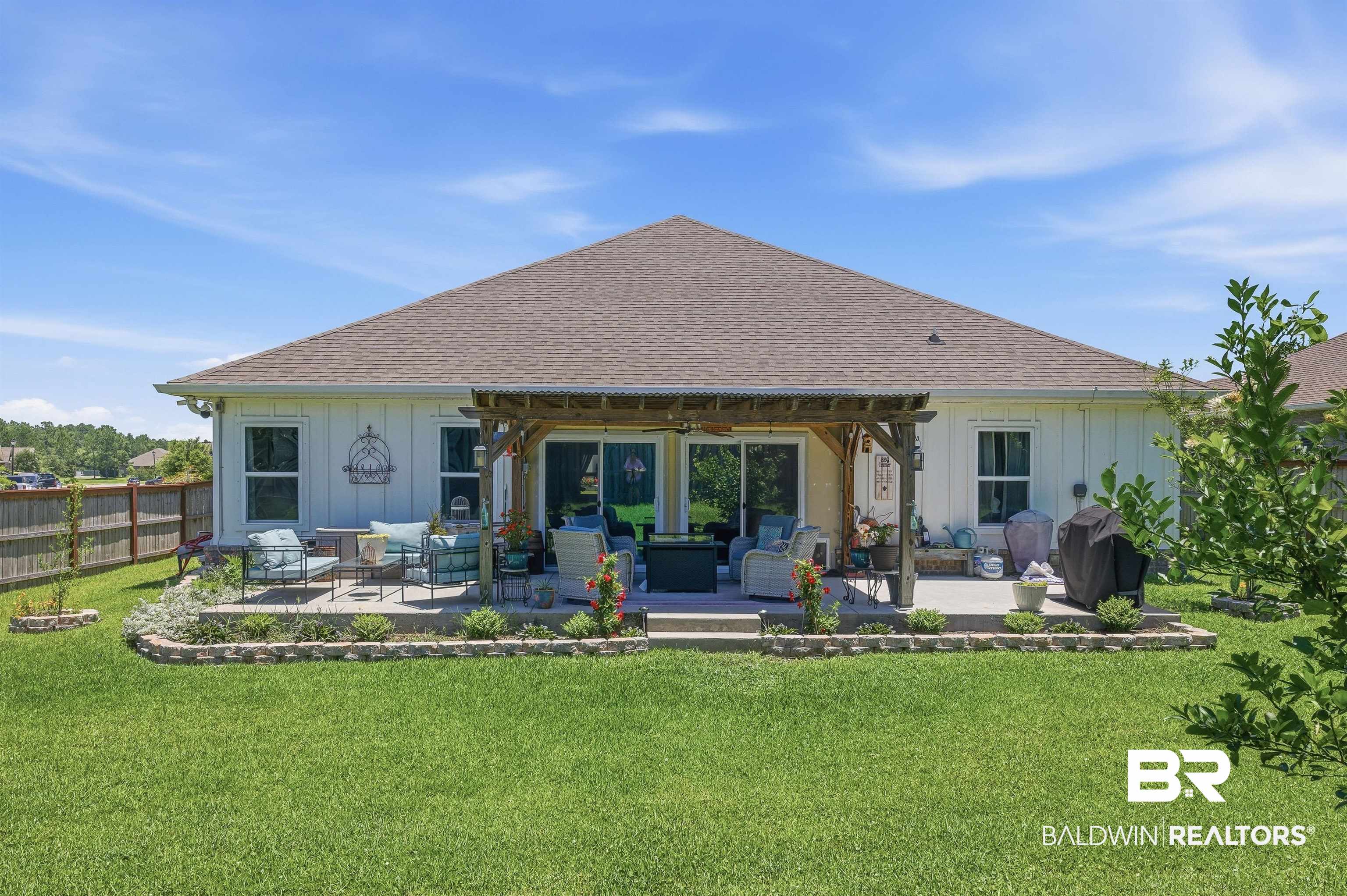 8735 Bronze Lane Foley, AL 36535 - Photo 45 of 58 Expansive backyard featuring a covered patio, pergola, and concrete paver patio