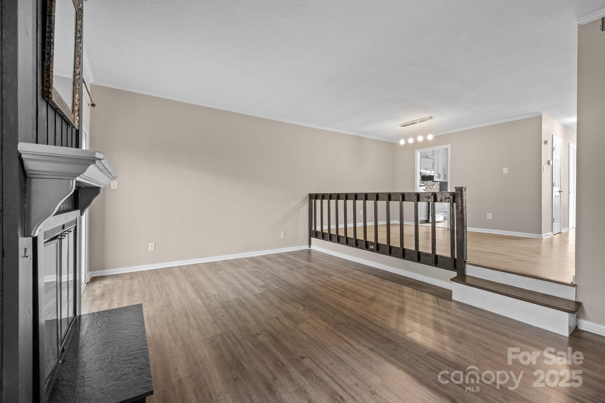 7939 Charter Oak Lane Charlotte, NC 28226 - Photo 12 of 28 a view of a room with wooden floor and stairs