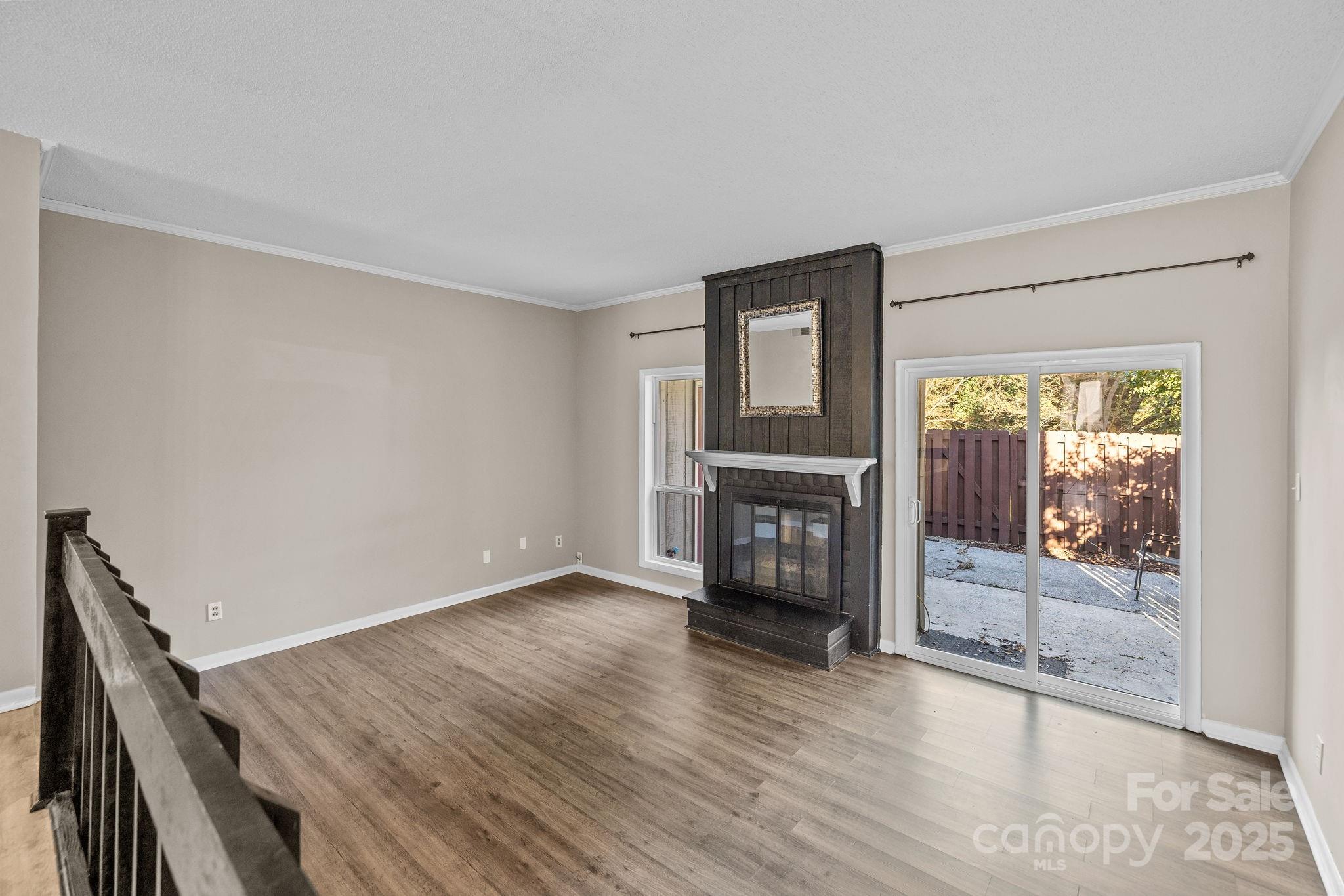 7939 Charter Oak Lane Charlotte, NC 28226 - Photo 14 of 28 a view of an empty room with wooden floor and a window