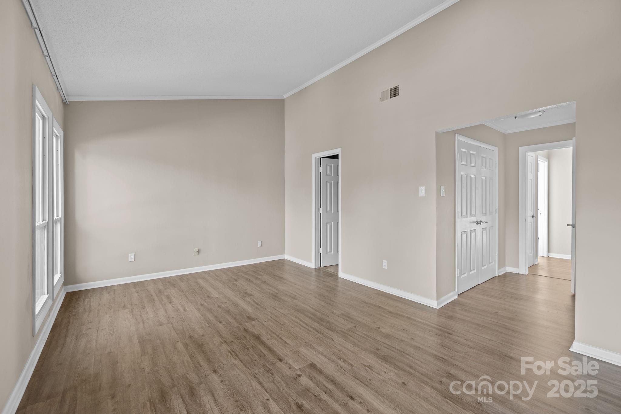 7939 Charter Oak Lane Charlotte, NC 28226 - Photo 18 of 28 a view of an empty room with wooden floor and a window