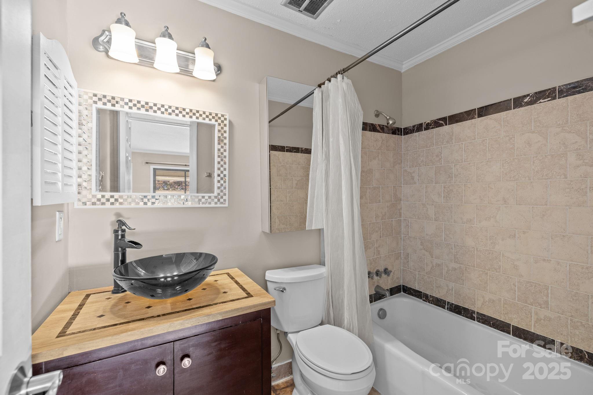 7939 Charter Oak Lane Charlotte, NC 28226 - Photo 19 of 28 a bathroom with a granite countertop sink mirror vanity and toilet
