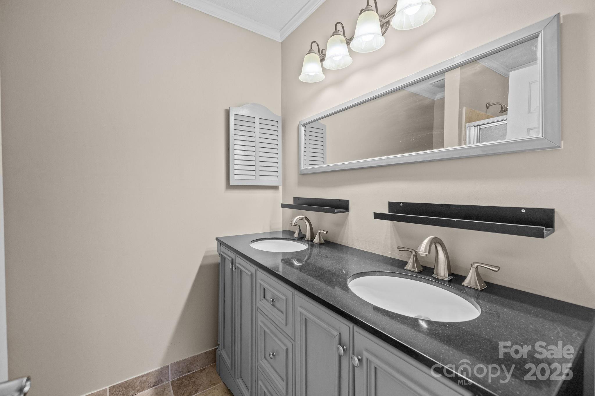 7939 Charter Oak Lane Charlotte, NC 28226 - Photo 22 of 28 a bathroom with a granite countertop double vanity and a mirror