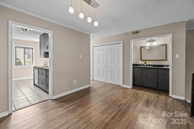 a view of a kitchen with wooden floor and electronic appliances