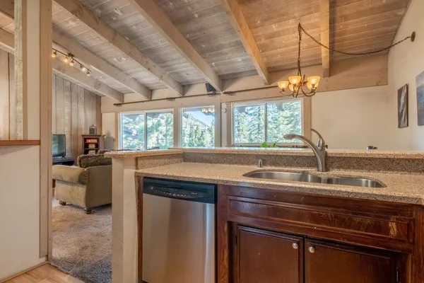 a kitchen with a sink appliances and a window
