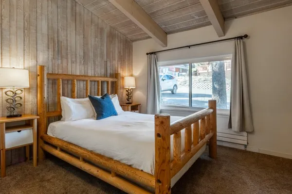 a bed sitting in a bedroom next to a window