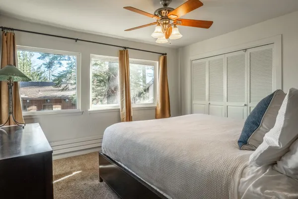 a bedroom with a large bed and a large window