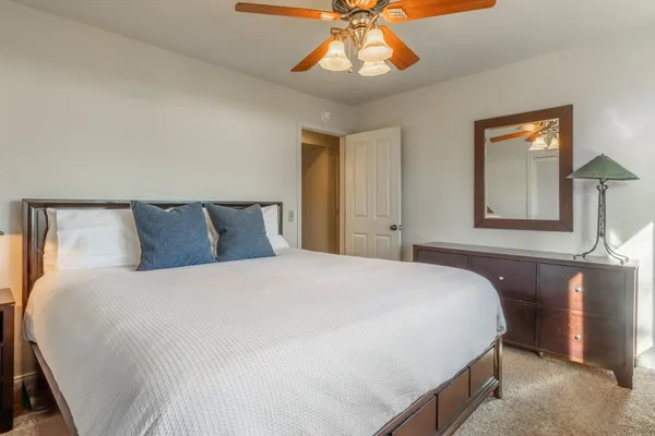 a bedroom with a bed and a chandelier