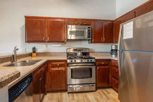 a kitchen with a sink stove and refrigerator