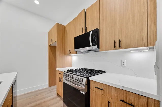 a kitchen with stainless steel appliances a stove and a microwave