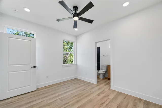 wooden floor in an empty room with a window