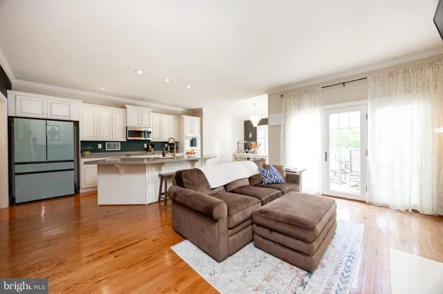a living room with furniture and kitchen view