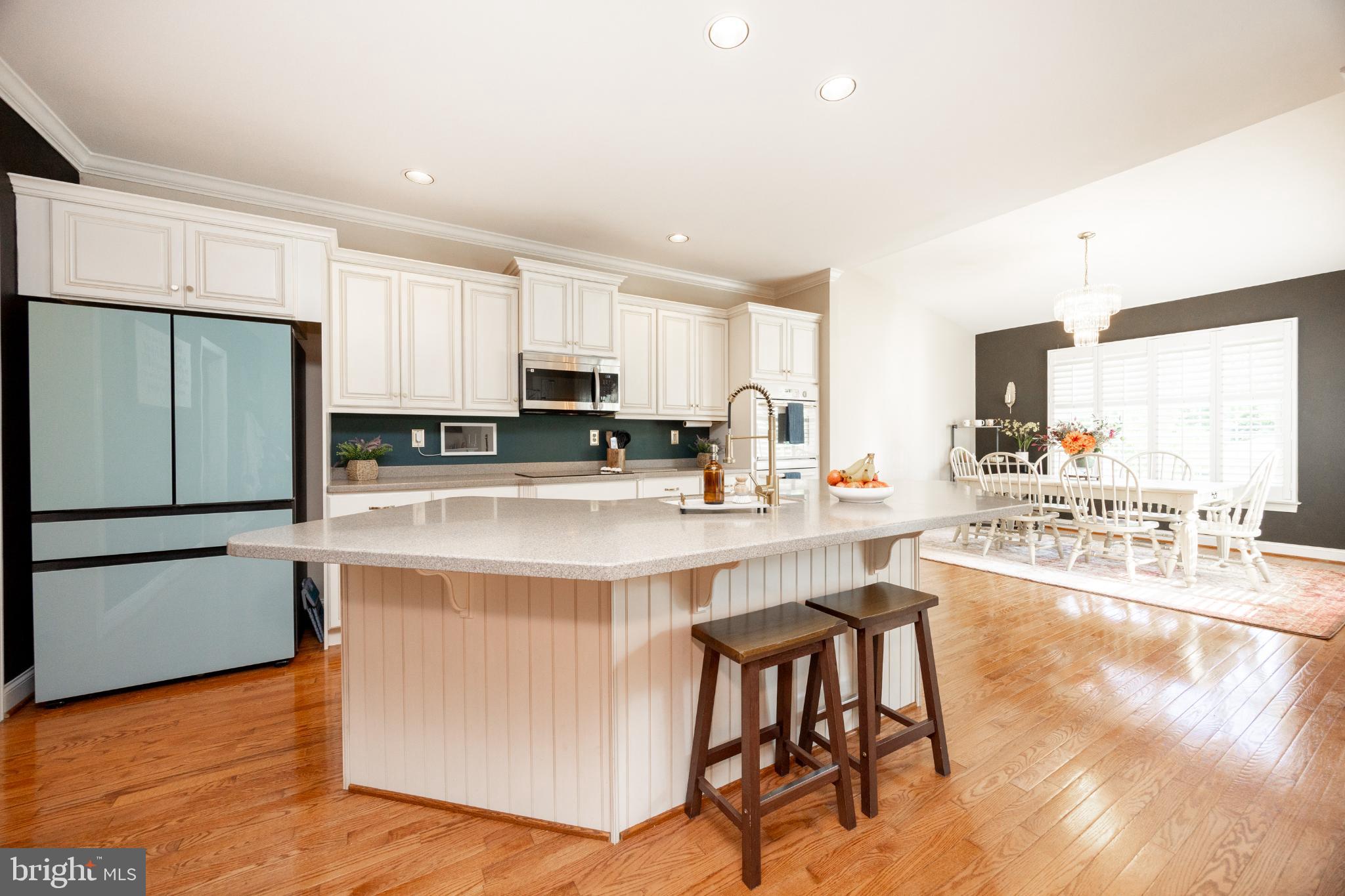 214 Windgate Drive Chester Springs, PA 19425 - Photo 14 of 45 a kitchen with stainless steel appliances a stove a sink a refrigerator white cabinets and wooden floor