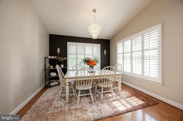 a view of a dining room with furniture wooden floor and a window