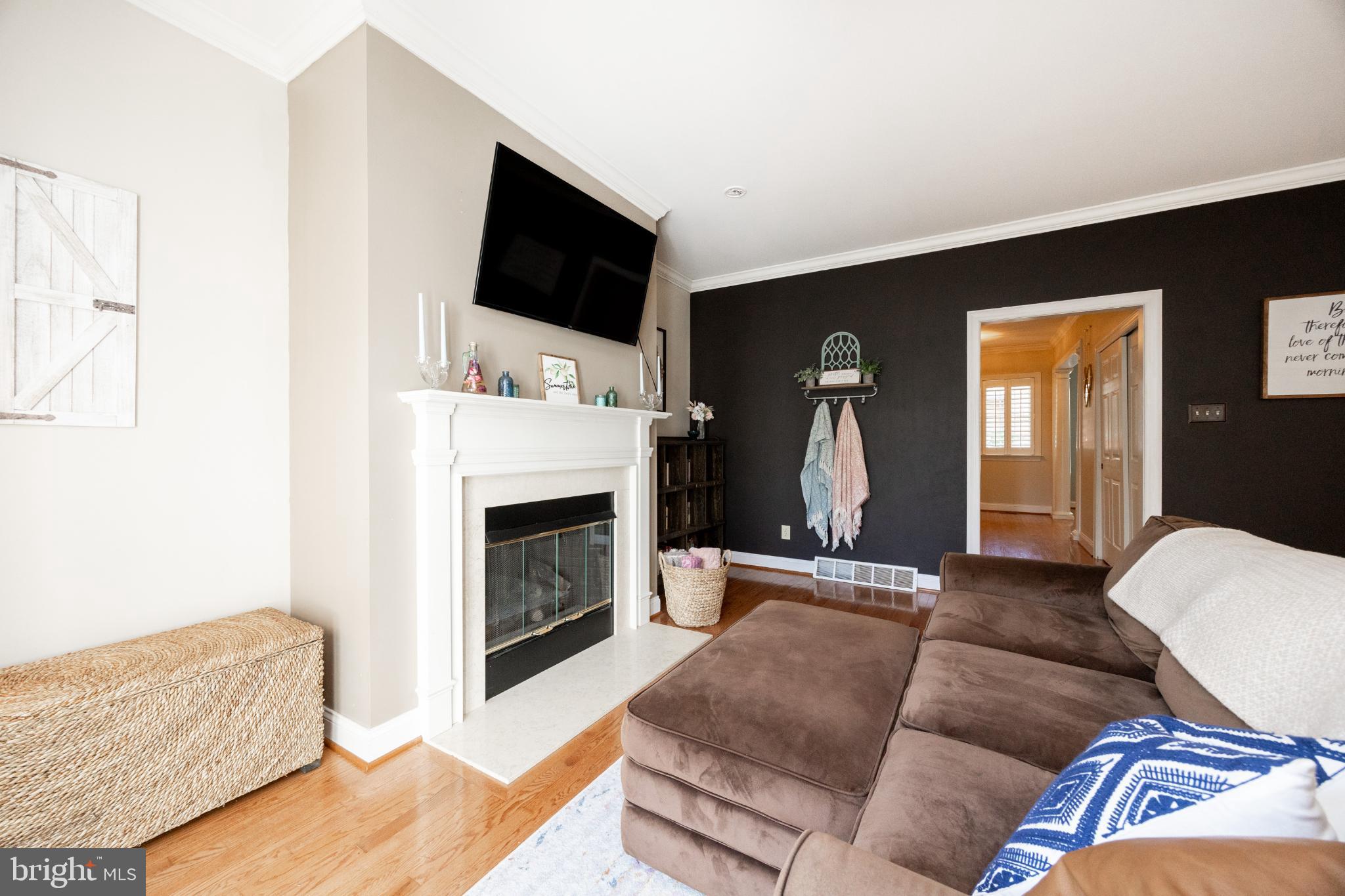 214 Windgate Drive Chester Springs, PA 19425 - Photo 18 of 45 a living room with furniture a flat screen tv and a fireplace