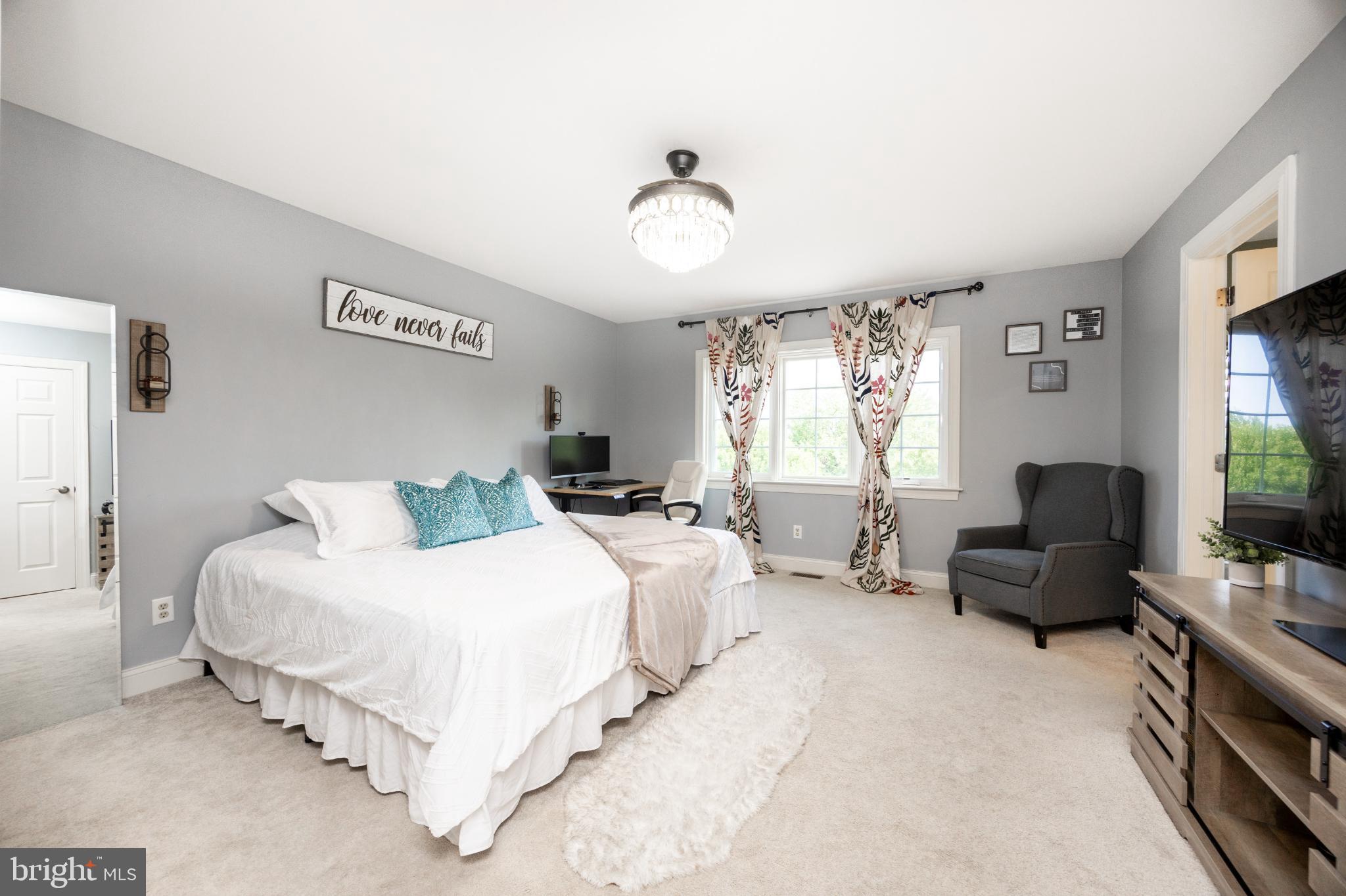 214 Windgate Drive Chester Springs, PA 19425 - Photo 21 of 45 a bedroom with bed couch and window