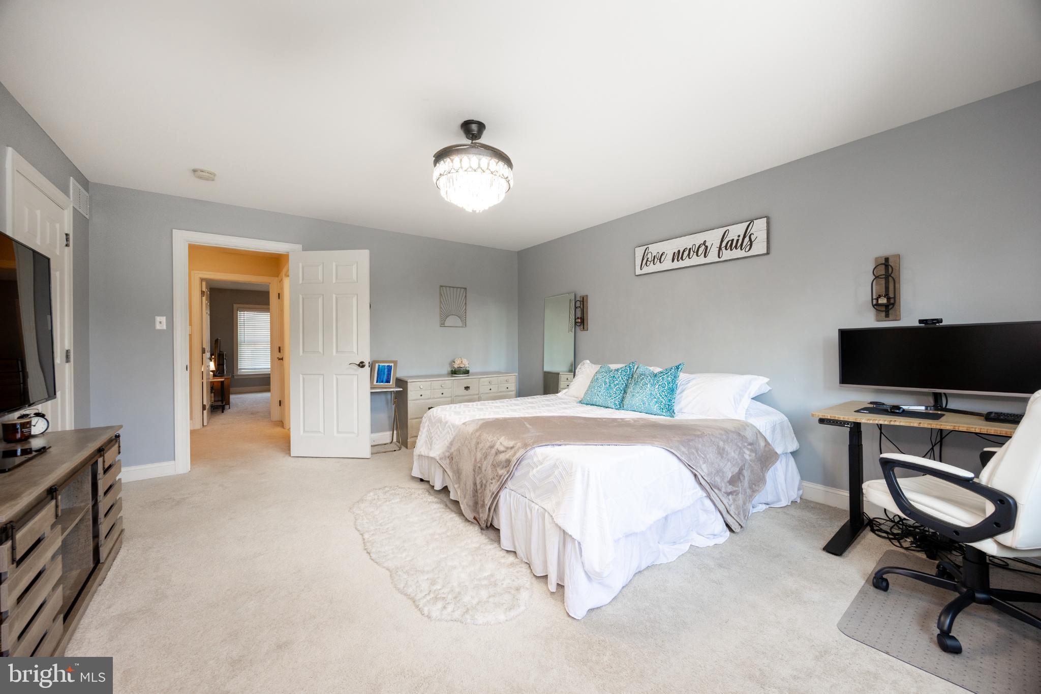 214 Windgate Drive Chester Springs, PA 19425 - Photo 22 of 45 a bedroom with a bed and a flat screen tv