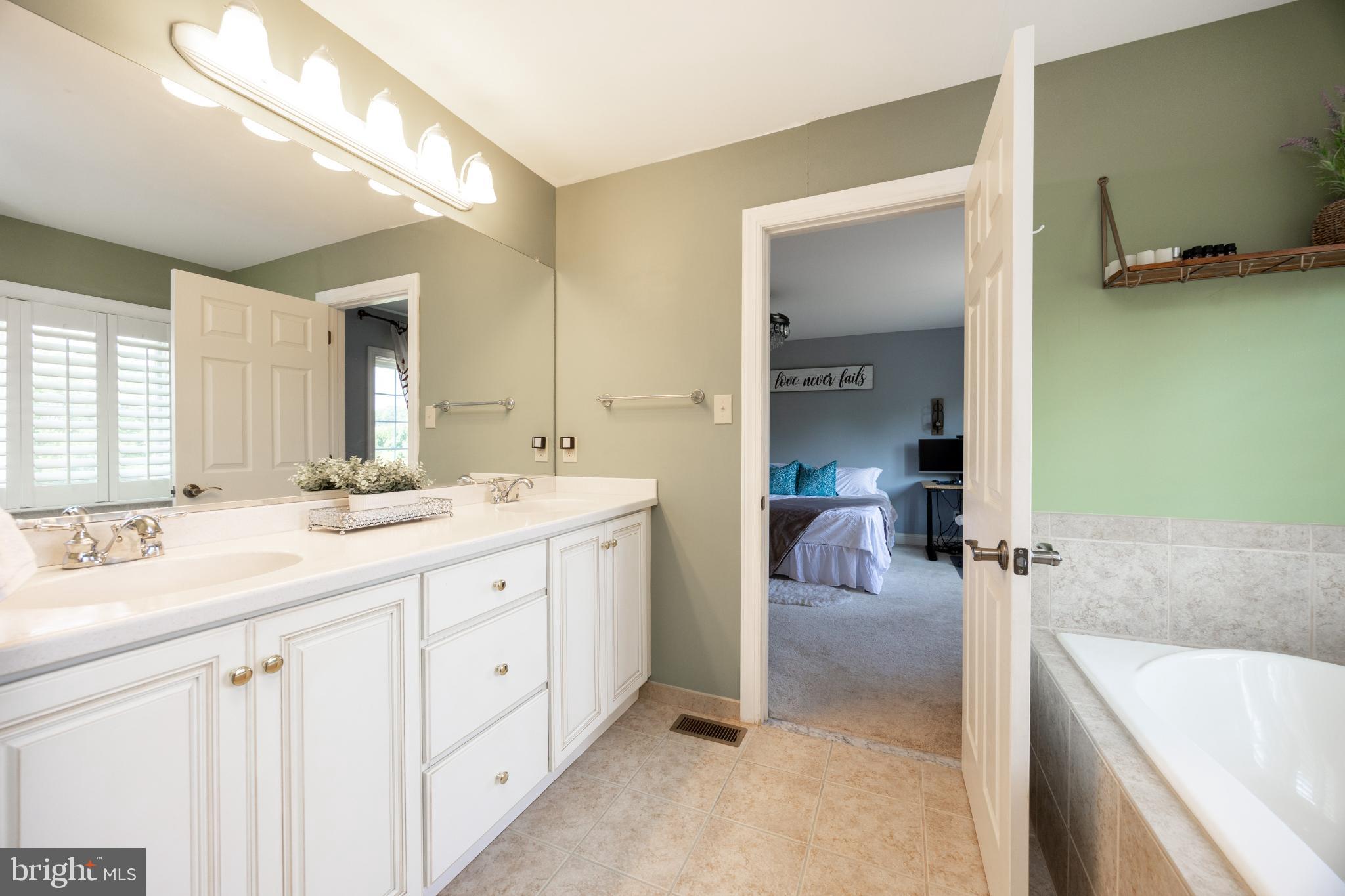 214 Windgate Drive Chester Springs, PA 19425 - Photo 25 of 45 a en suite bathroom with a granite countertop sink and a mirror