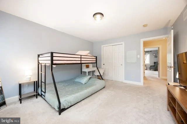 a room with a washing machine and a view of living room