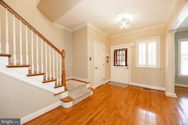 a view of an empty room with stairs and a window