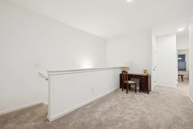 a bedroom with a bed and a dresser next to a window