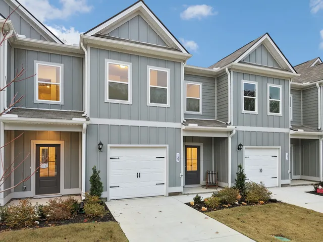 an aerial view of a house with a yard and mountain view in back