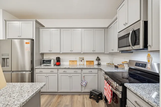 a living room with furniture and a table with wooden floor