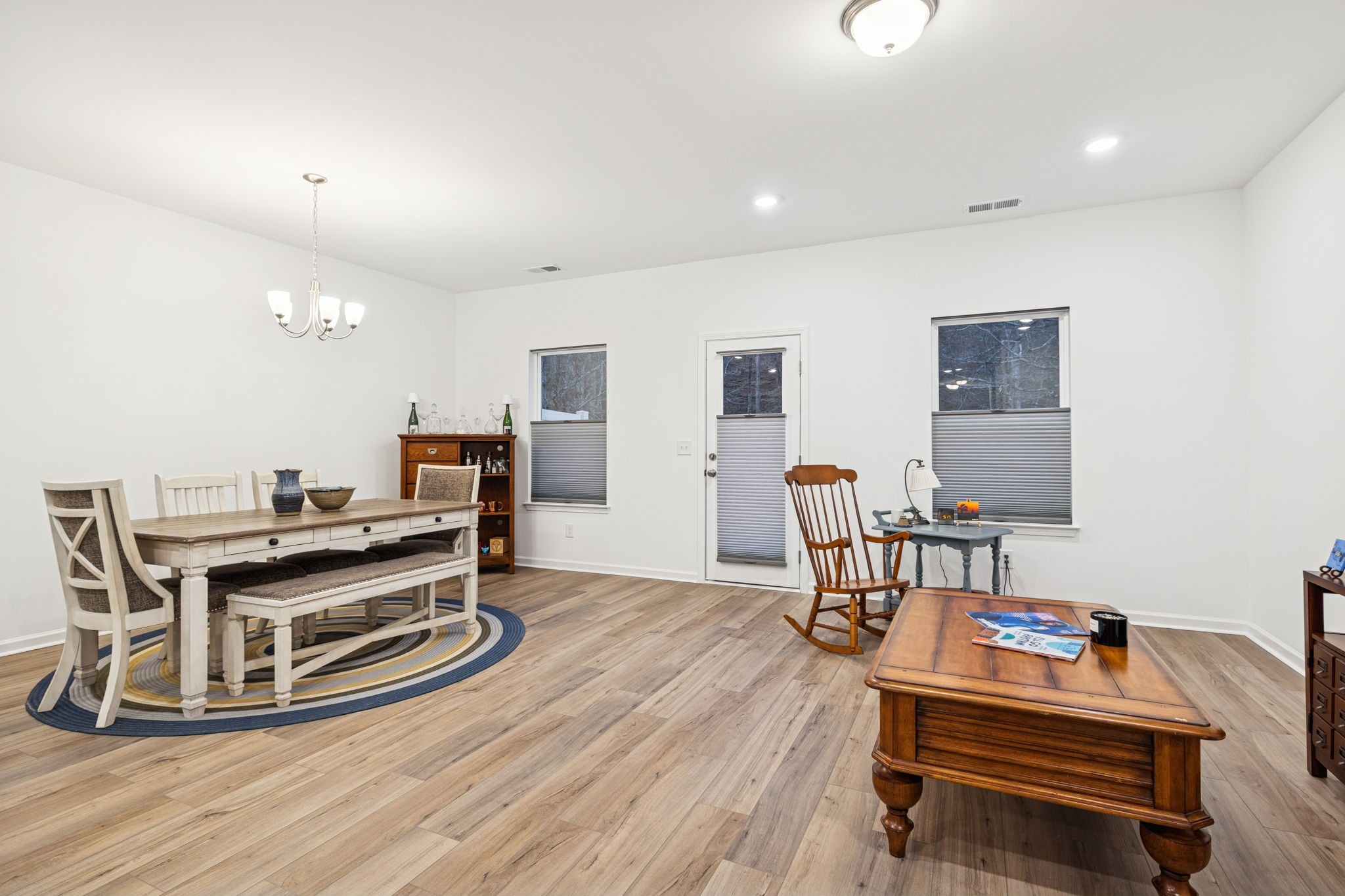 129 Ironhorse Way Dickson, TN 37055 - Photo 9 of 35 a room with a table chairs and entryway with wooden floor