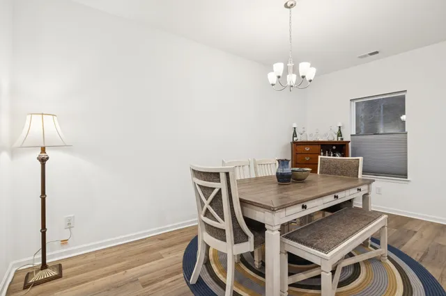 a bedroom with a bed and a flat tv screen on the dresser