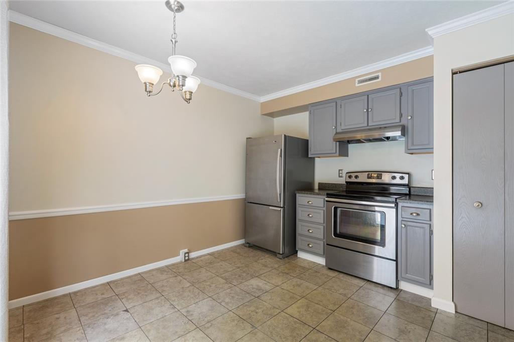 2003 Timber Trail Imperial, PA 15126 - Photo 9 of 18 a kitchen with kitchen island white cabinets and stainless steel appliances