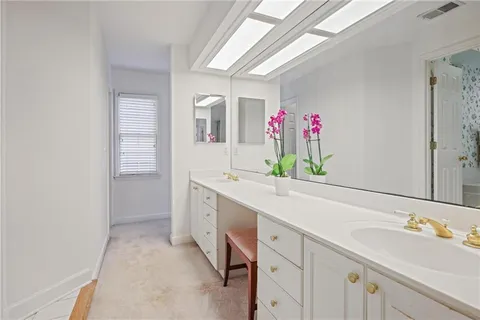 a spacious bathroom with a sink and a mirror