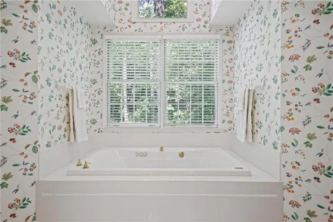 a bathroom with a bathtub and shower