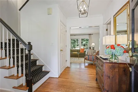 a hallway with wooden floor and flower pot