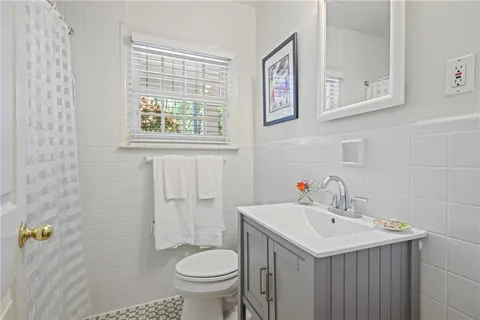 a bathroom with a sink toilet and a mirror