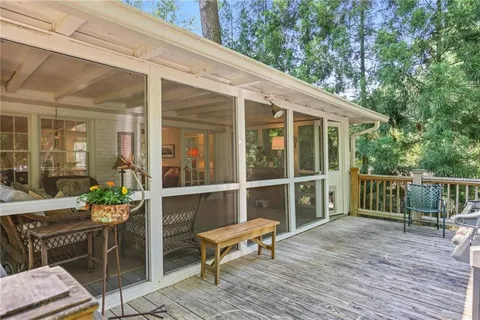 a balcony with furniture and wooden floor