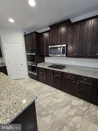 a stove top oven sitting inside of a kitchen