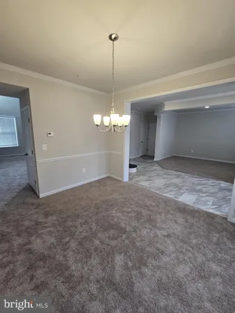 a kitchen with stainless steel appliances granite countertop wooden cabinets a refrigerator and a sink