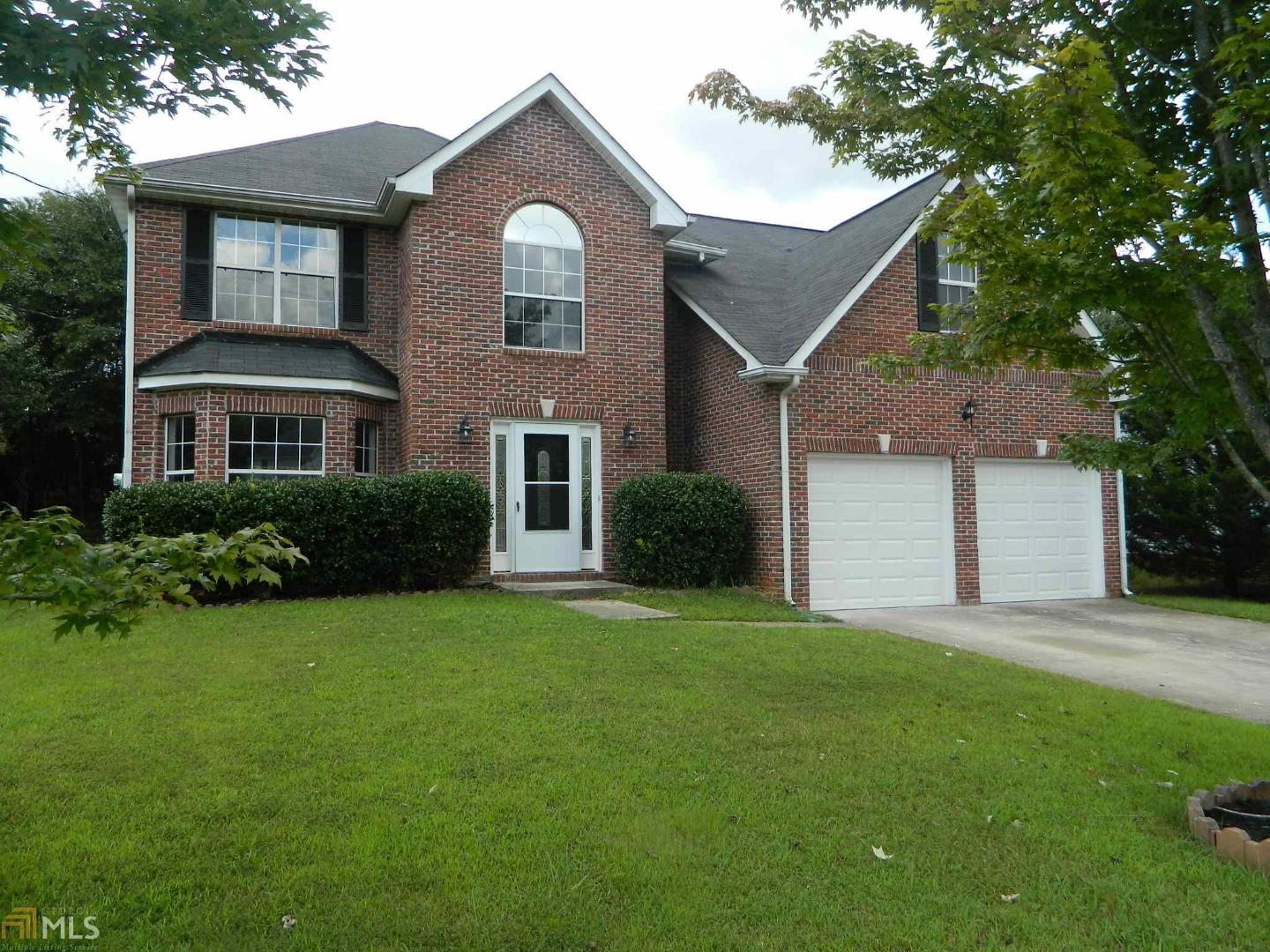 2103 Redwater Drive Decatur, GA 30035 - Photo 1 of 1 a front view of a house with a yard and garage