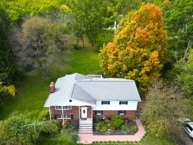 an aerial view of a house with swimming pool and garden