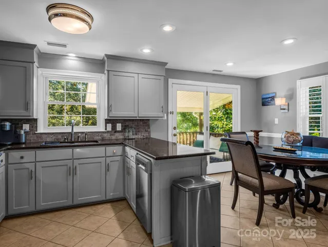 a kitchen with a refrigerator a sink a stove a microwave and cabinets