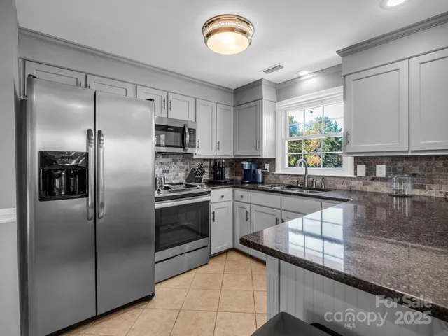a kitchen with cabinets appliances and a sink