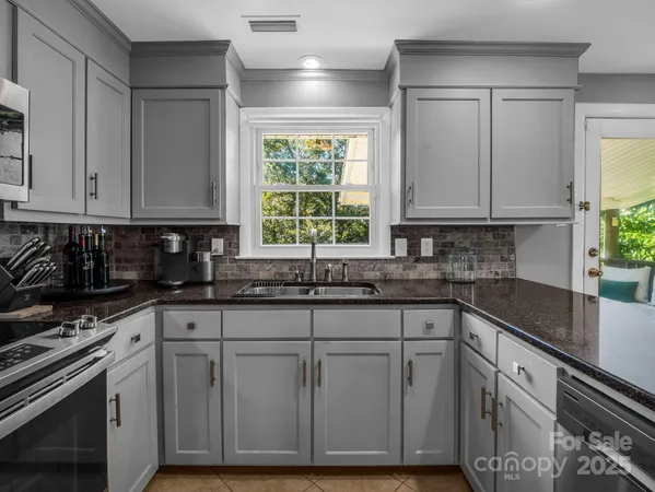 a kitchen with stainless steel appliances granite countertop a refrigerator and a stove top oven