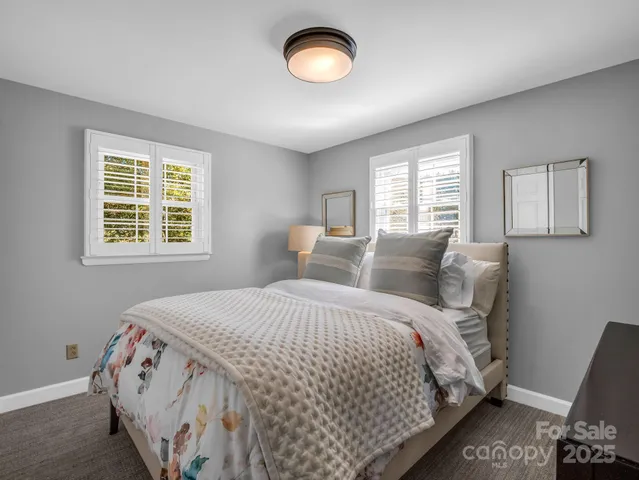 a bathroom with a sink vanity mirror and toilet