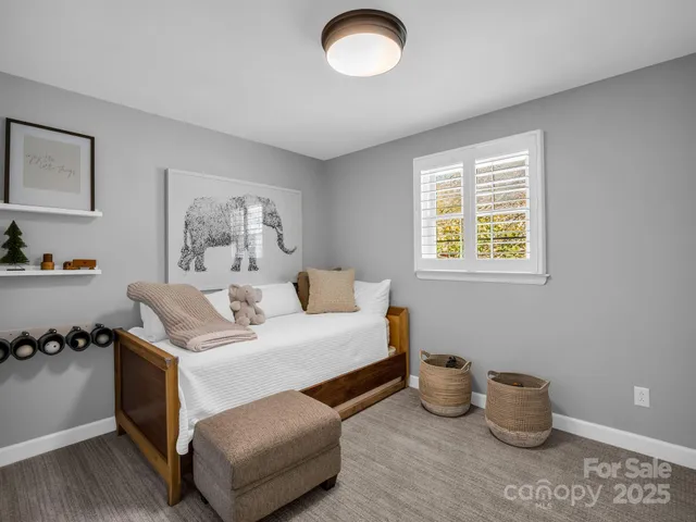 a bedroom with a bed and a couch