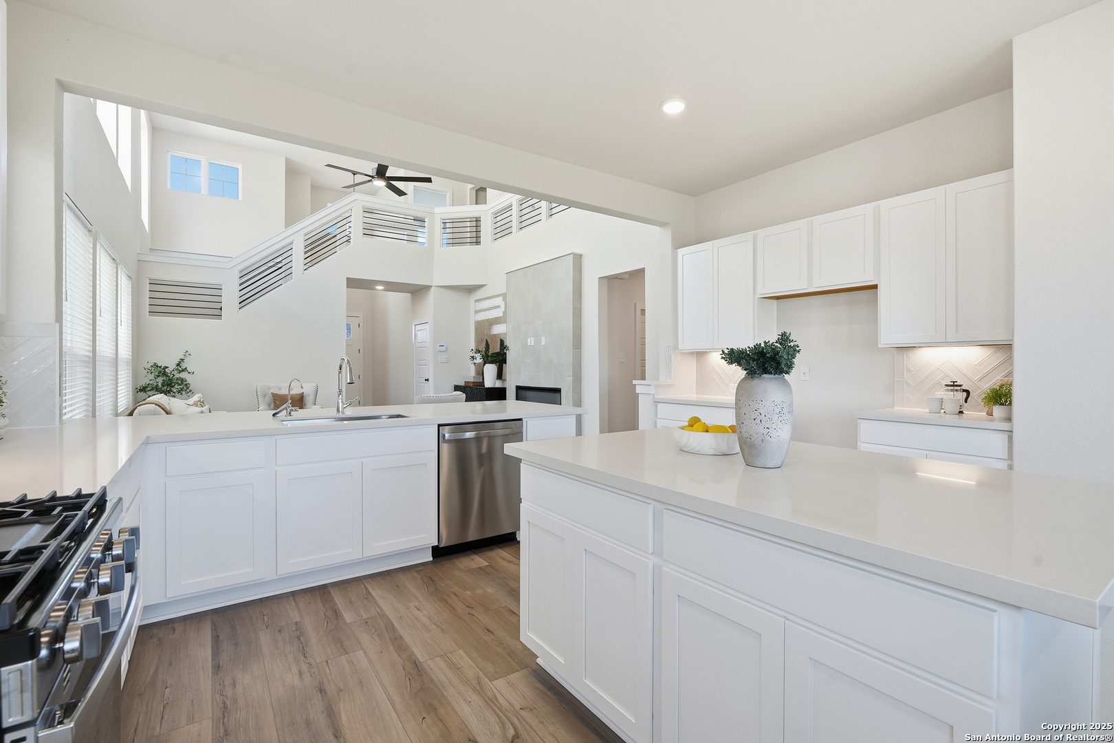 178 Jax Loop San Antonio, TX 78253 - Photo 17 of 45 a kitchen with a sink dishwasher a stove and white cabinets with wooden floor