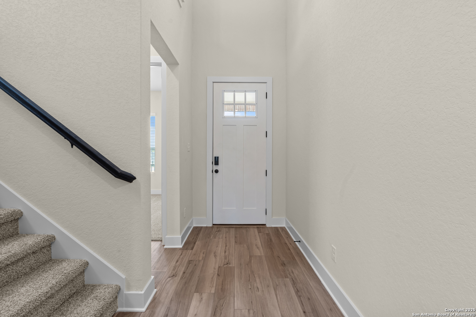 178 Jax Loop San Antonio, TX 78253 - Photo 6 of 45 a view of a hallway with wooden floor and staircase