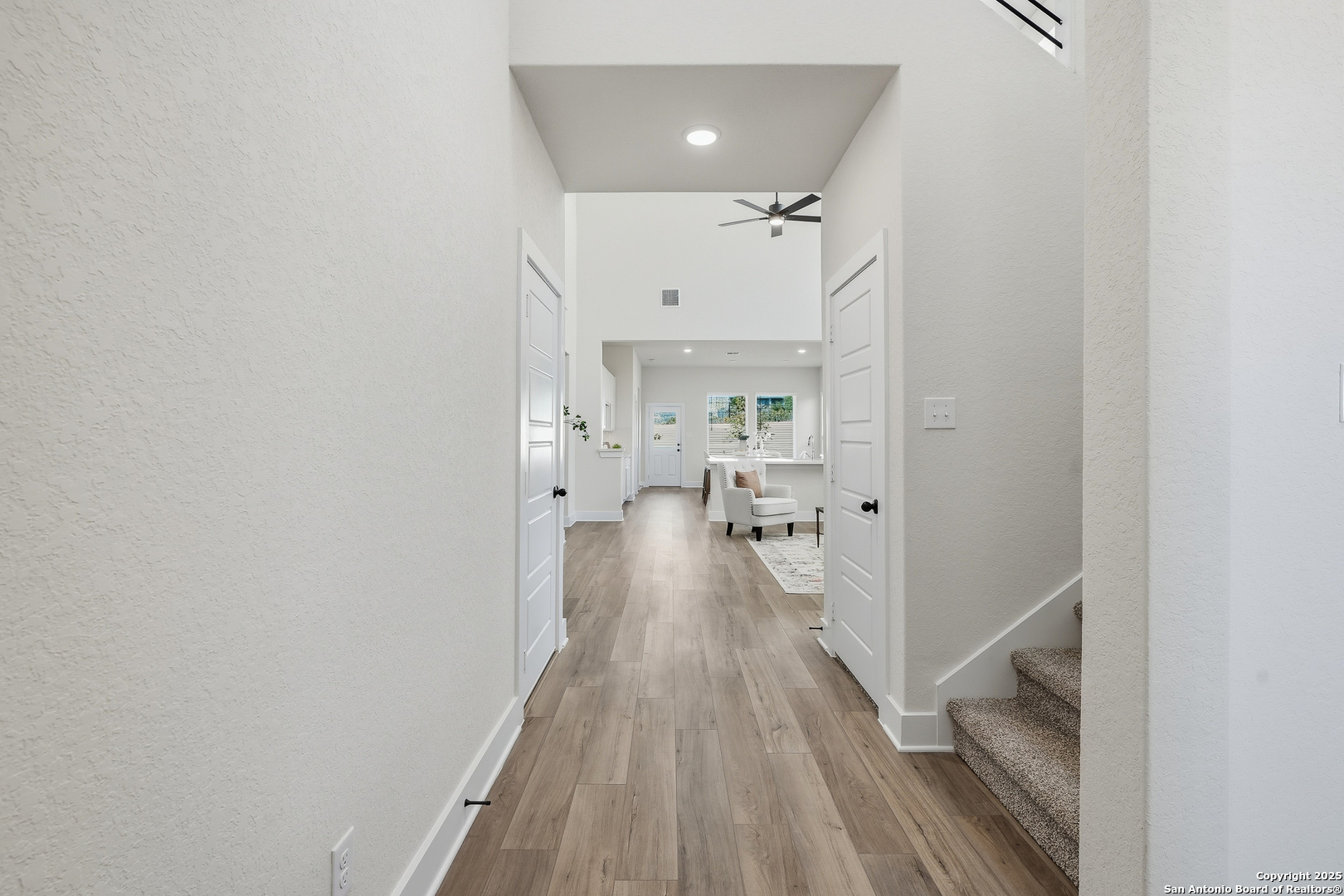178 Jax Loop San Antonio, TX 78253 - Photo 7 of 45 a view of a hallway with wooden floor and staircase